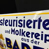 Badener Molkerei - Pasteurisierte Milch und Molkereiprodukte (Gewölbtes Emailleschild aus Österreich/ Um 1925)