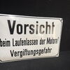 Vorsicht beim Laufenlassen der Motore! Vergiftungsgefahr (Gewölbtes Emailleschild um 1950)